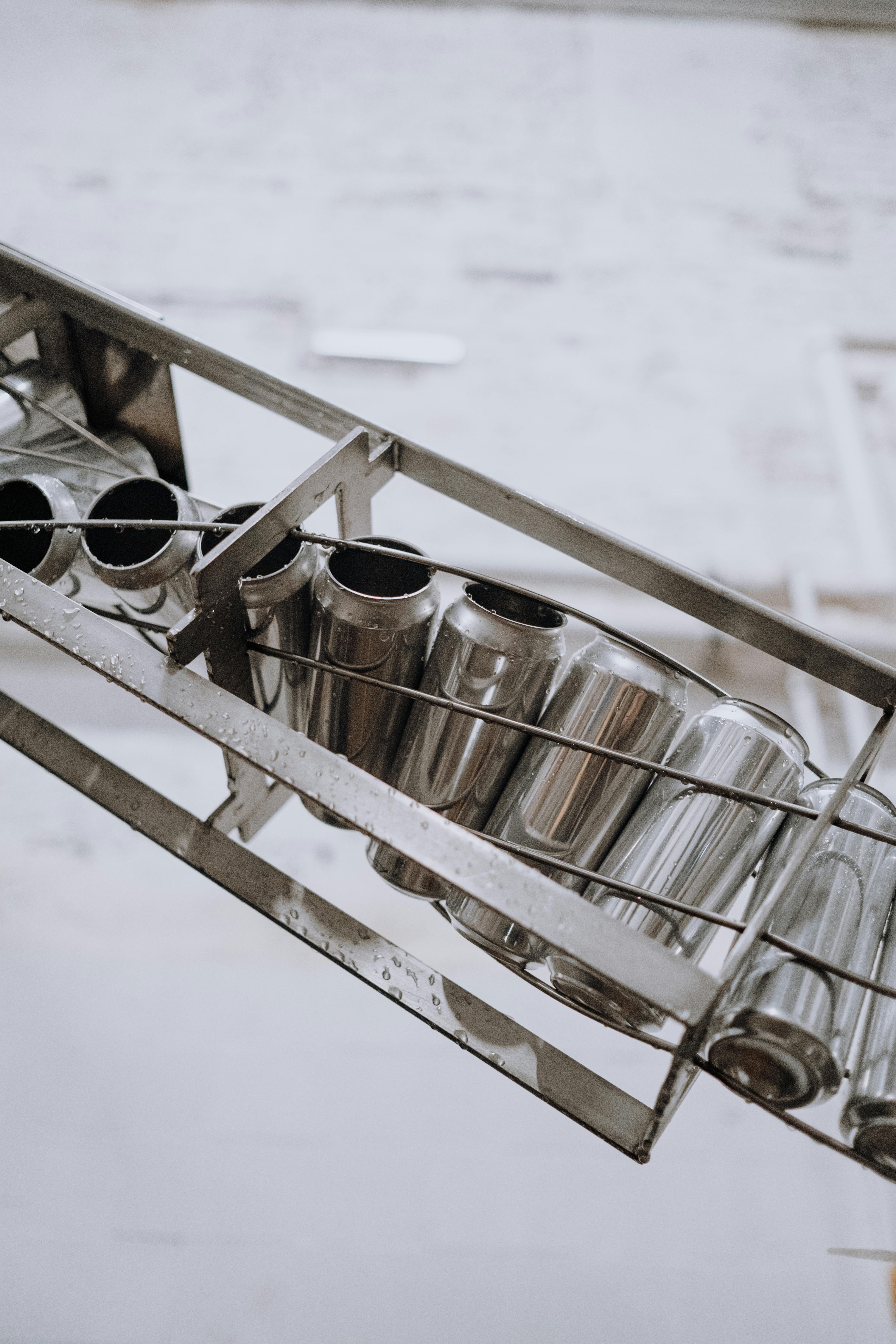 Silver cans on a manufacturing conveyor belt