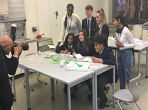 A group of young people in a classroom having their photo taken