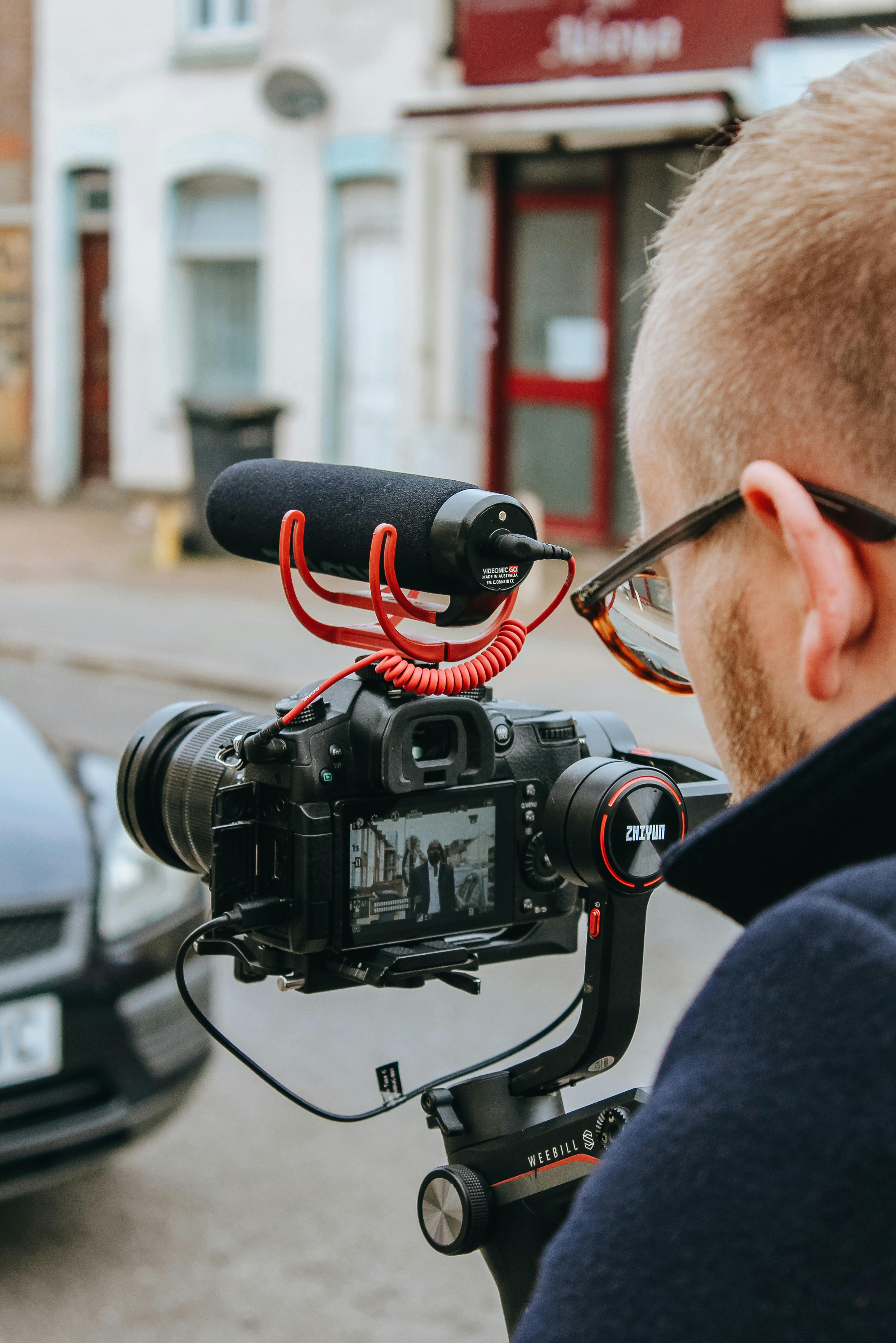 A man working with a professional camera and microphone