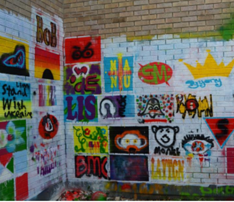 A brick wall covered in graffiti
