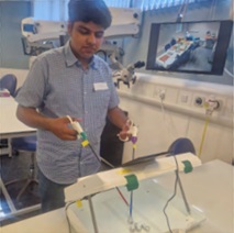 A young man using medical robotic arms