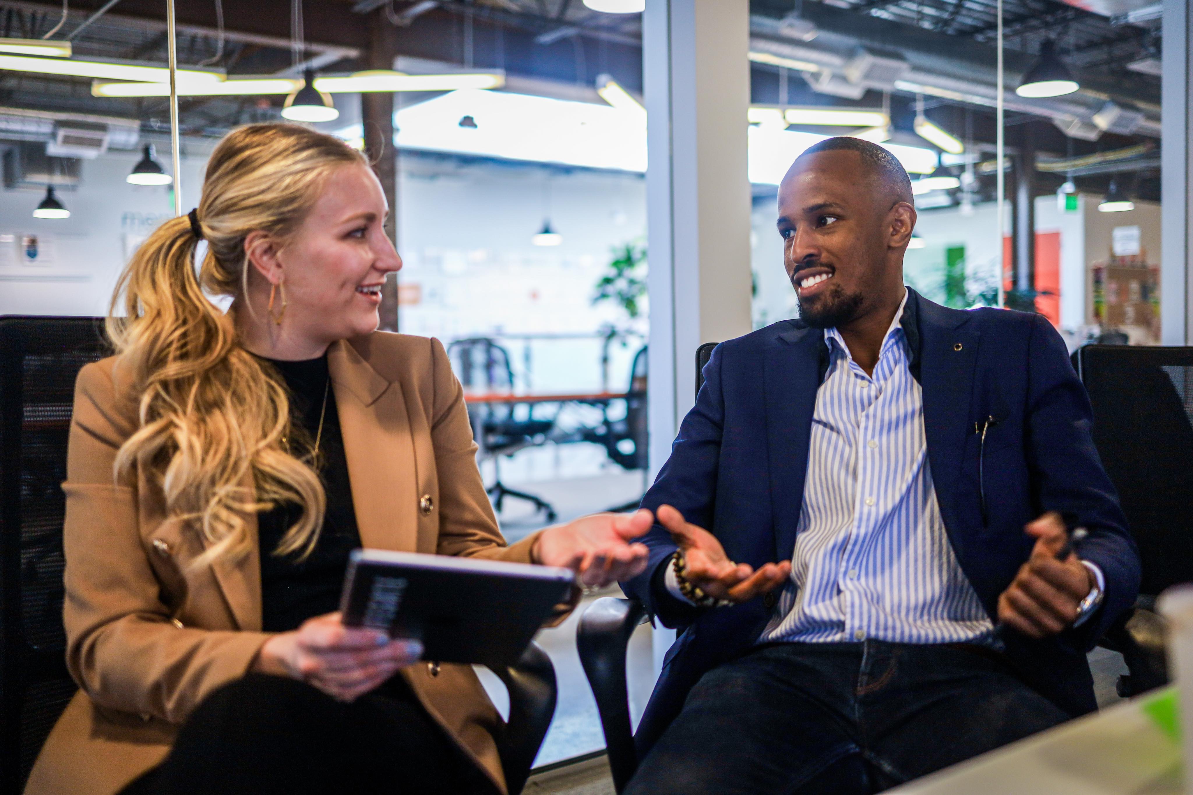 Woman and a man both in workwear having a conversation