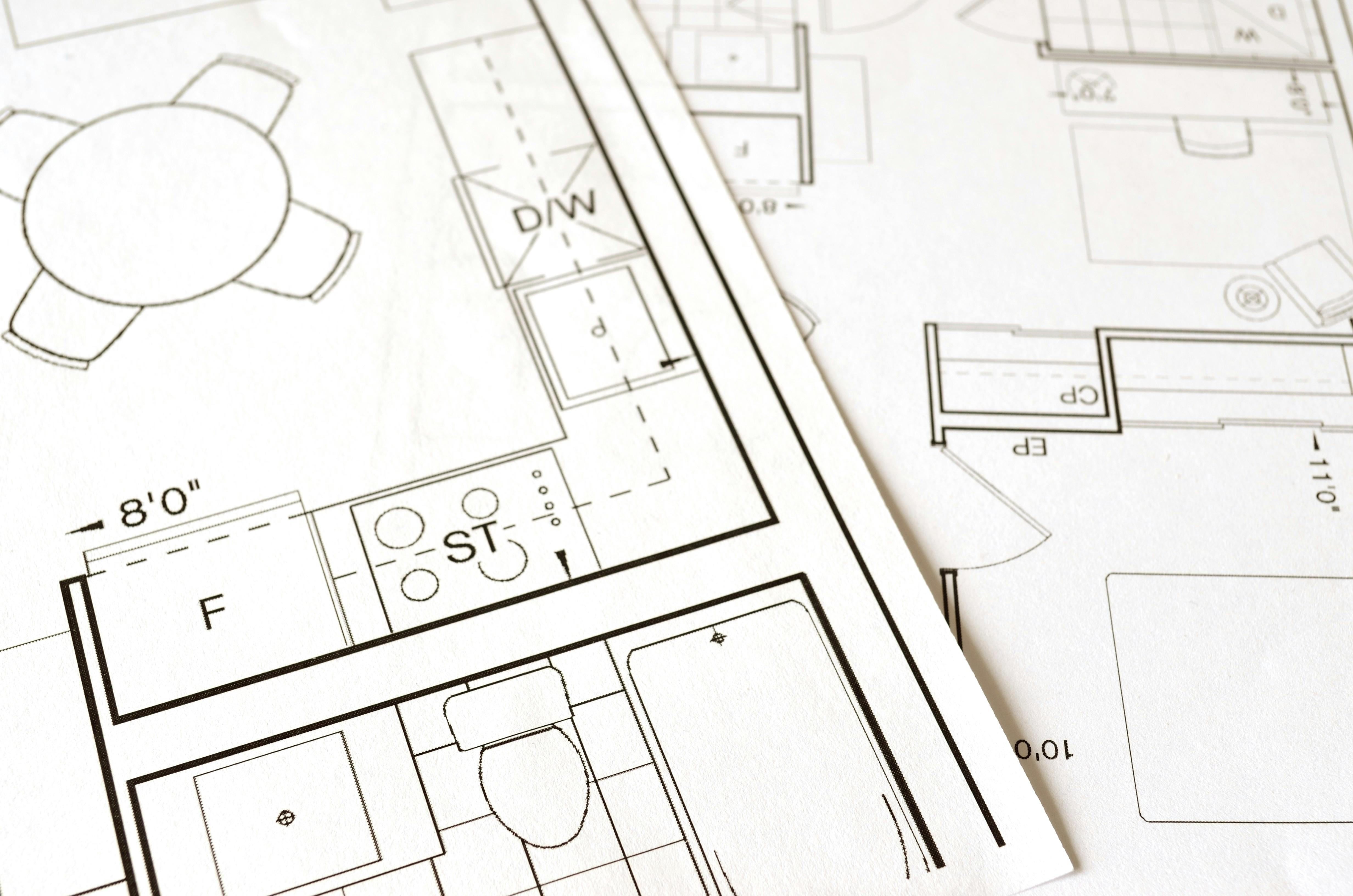 Two papers with architects plans on