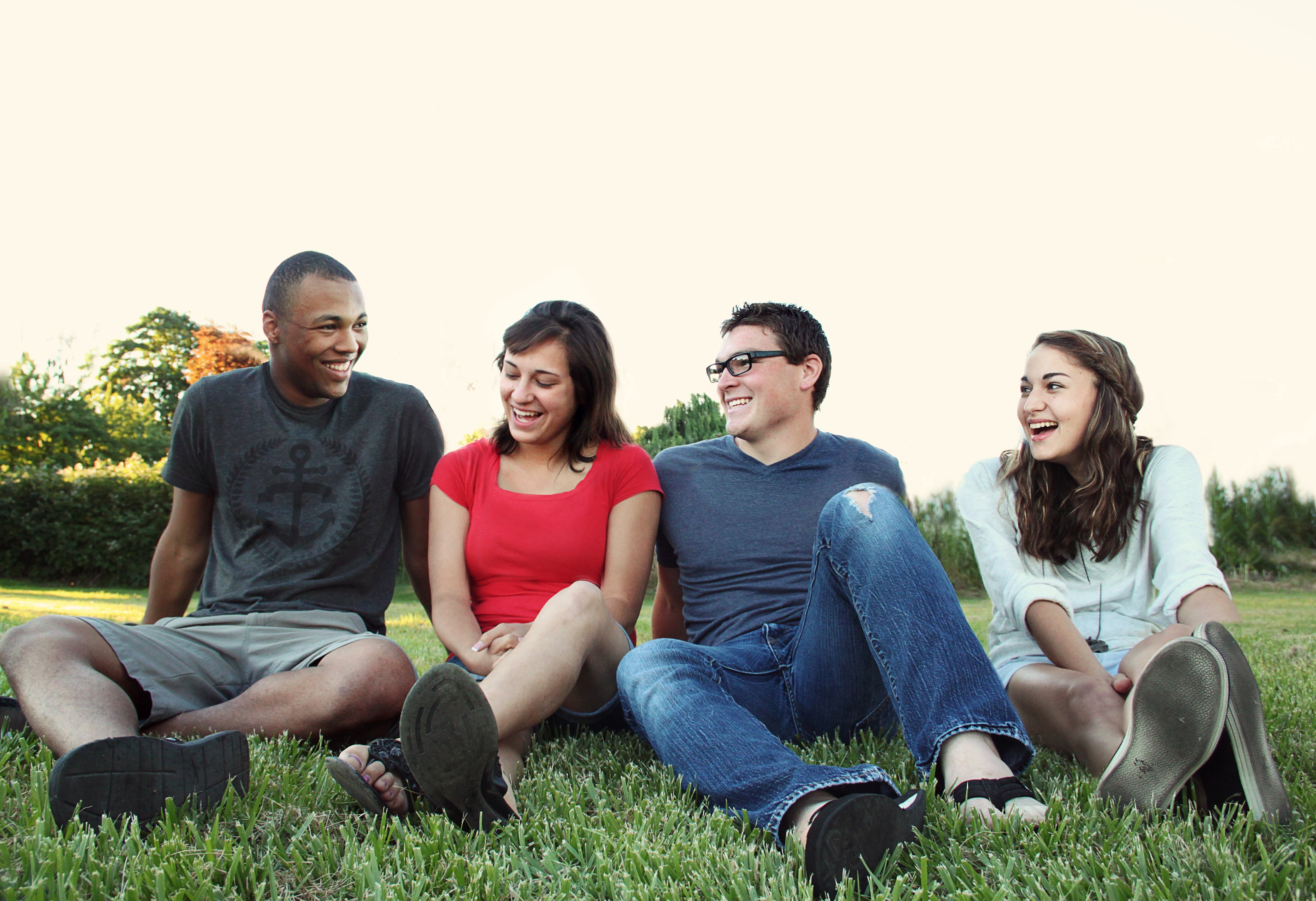 Four young people sat on grass