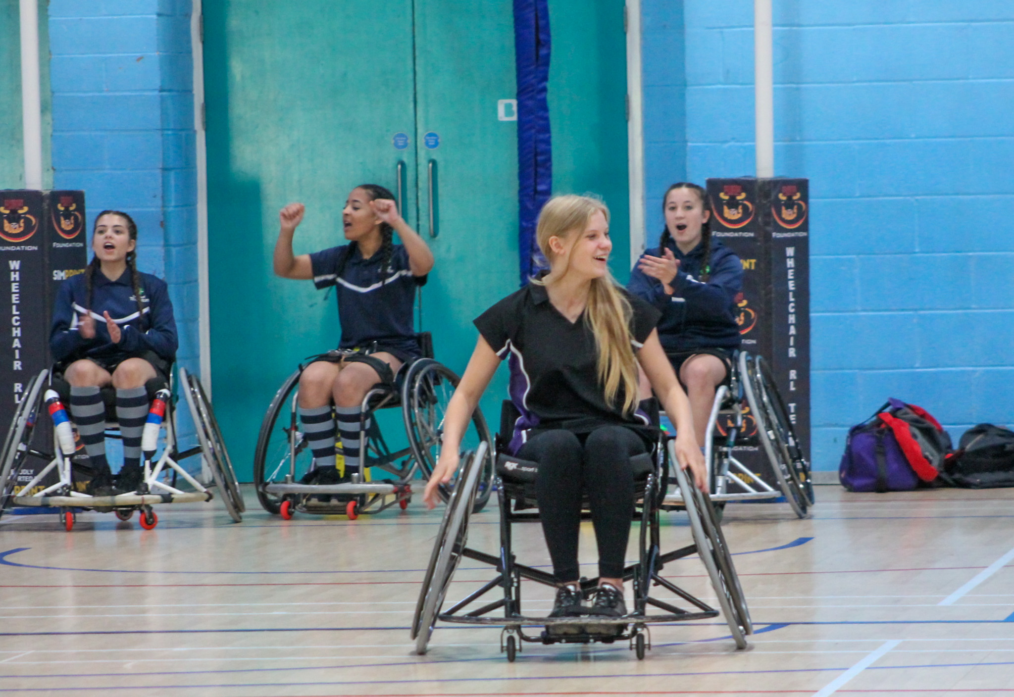 A group of girls in wheelchairs playing rugby