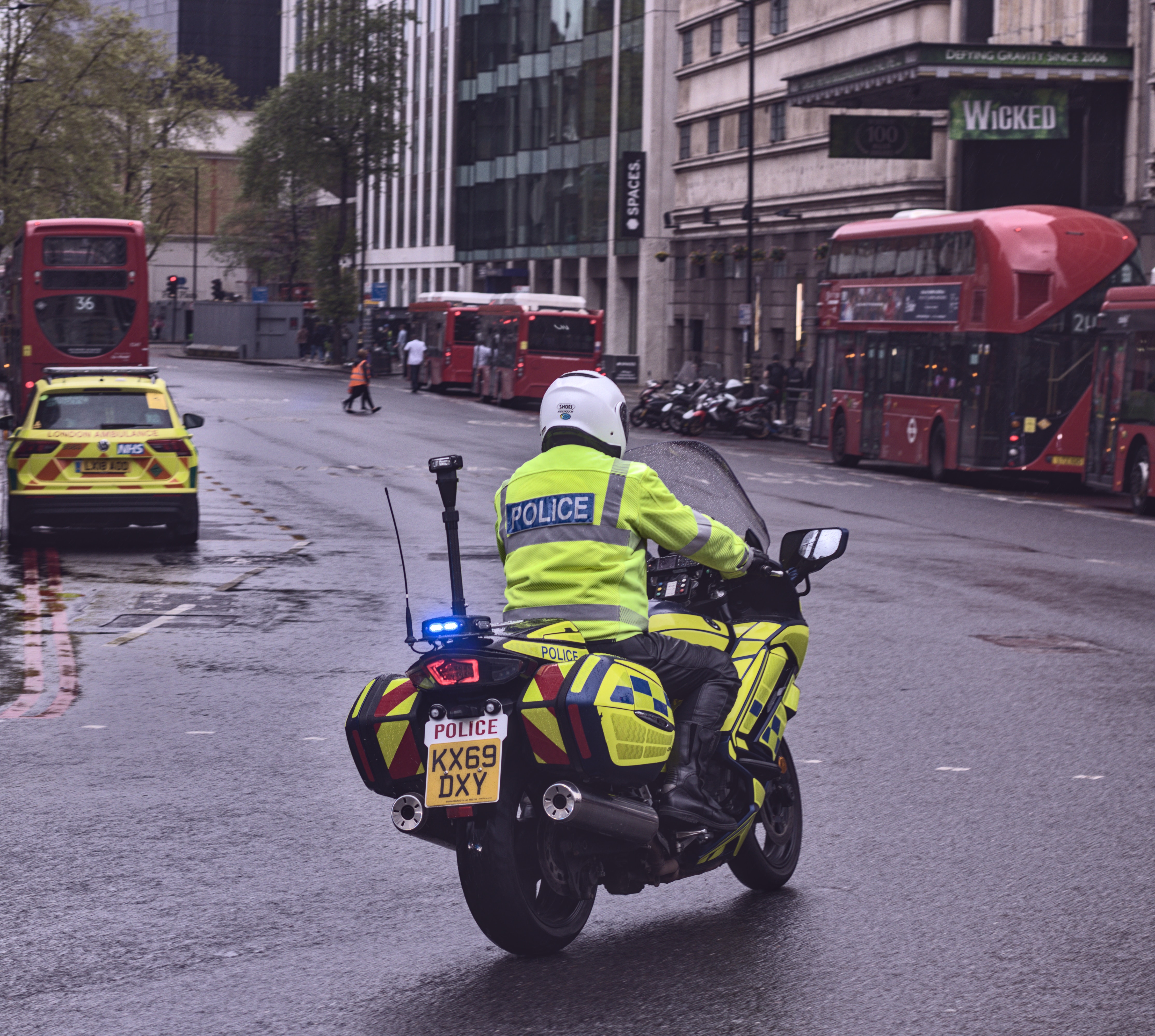 A policeman riding a police motorbike on a city street
