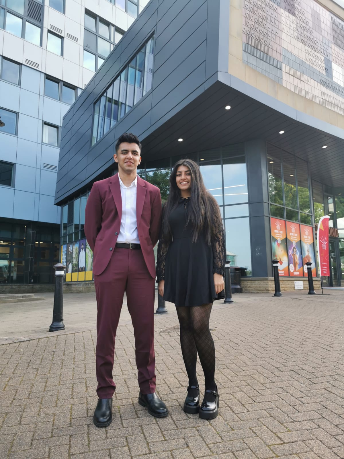 A young man and woman stood outside Bradford College