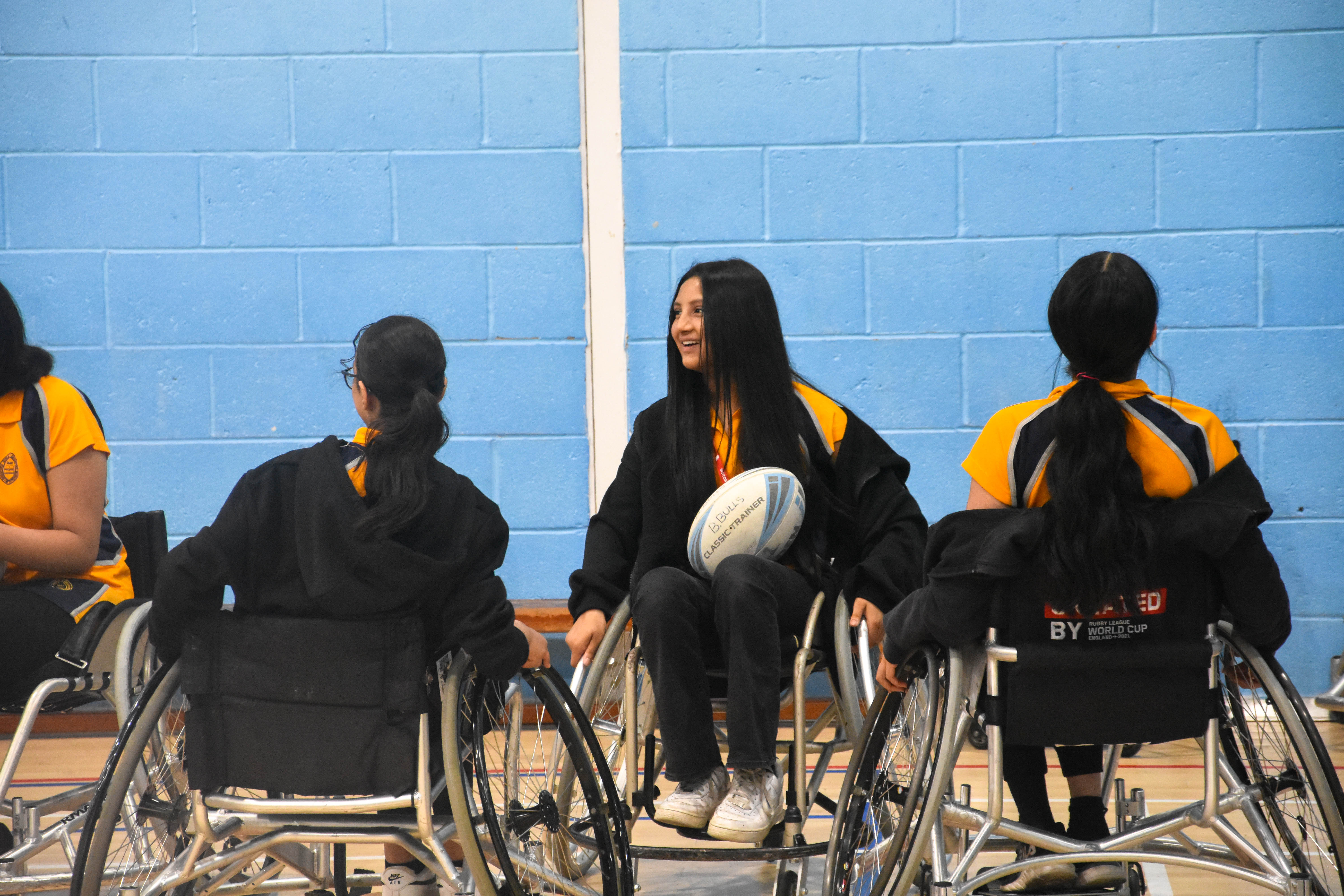 A group of girls in wheelchairs playing rugby