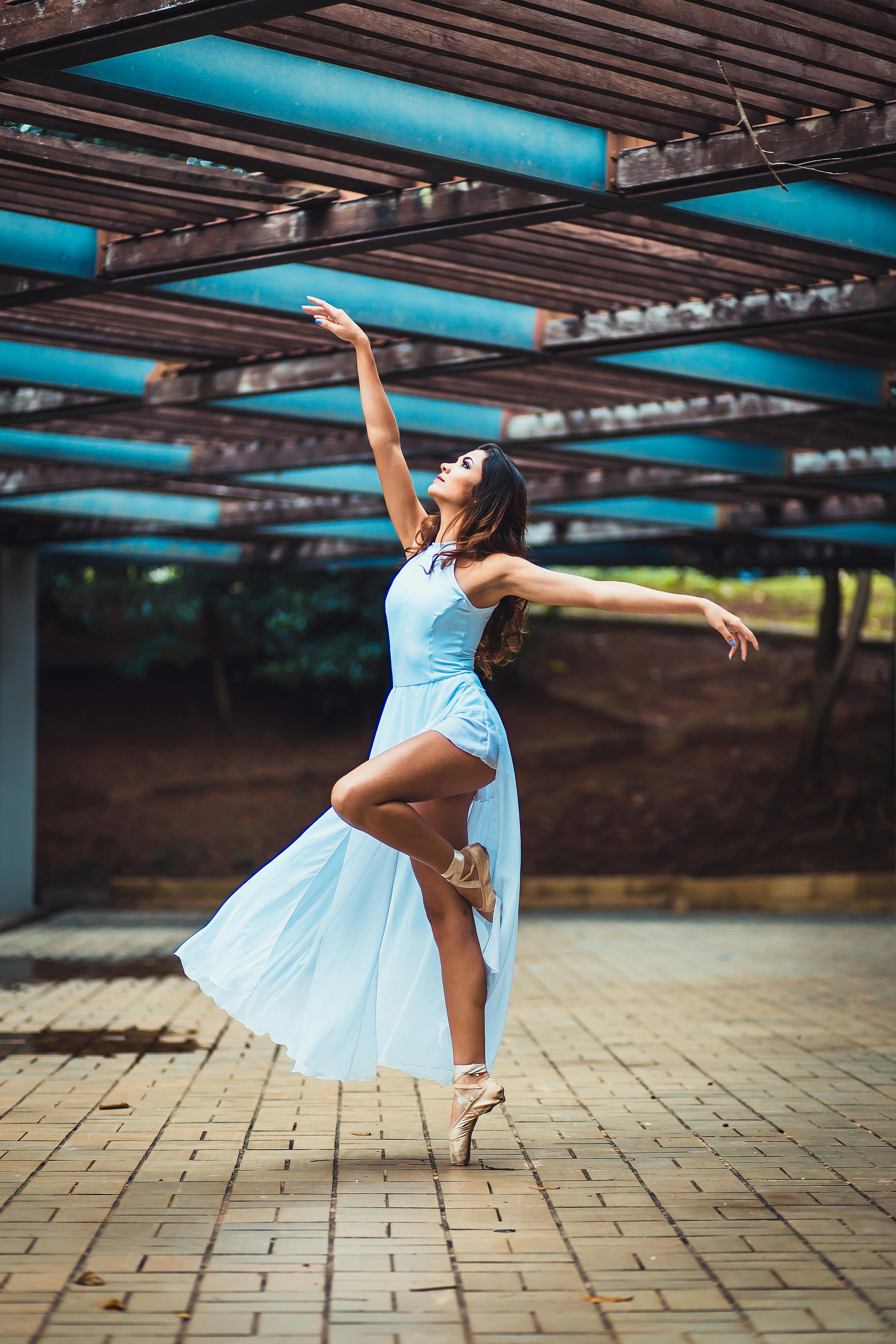 A ballerina in a long dress and pointe shoes