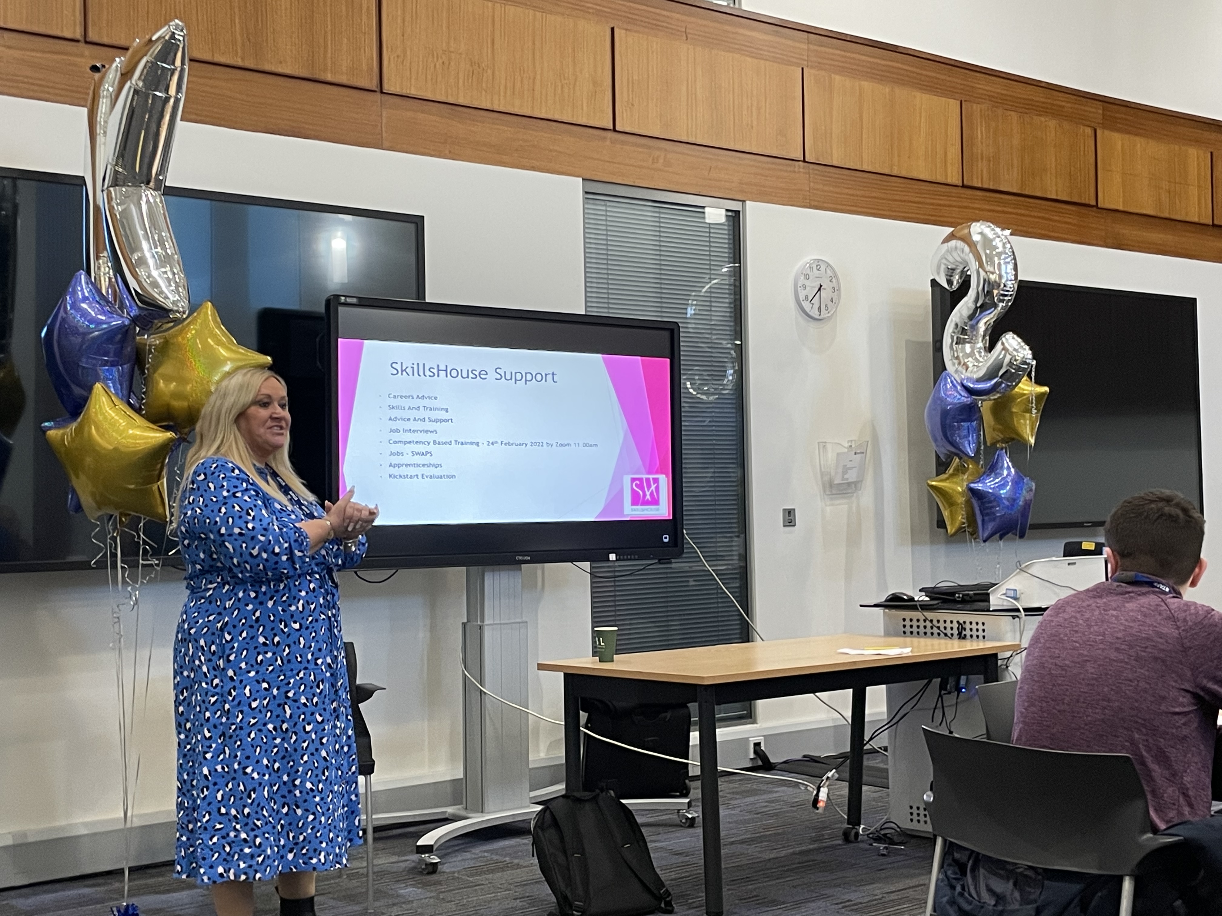 SkillsHouse employee presenting a slideshow to a room of people