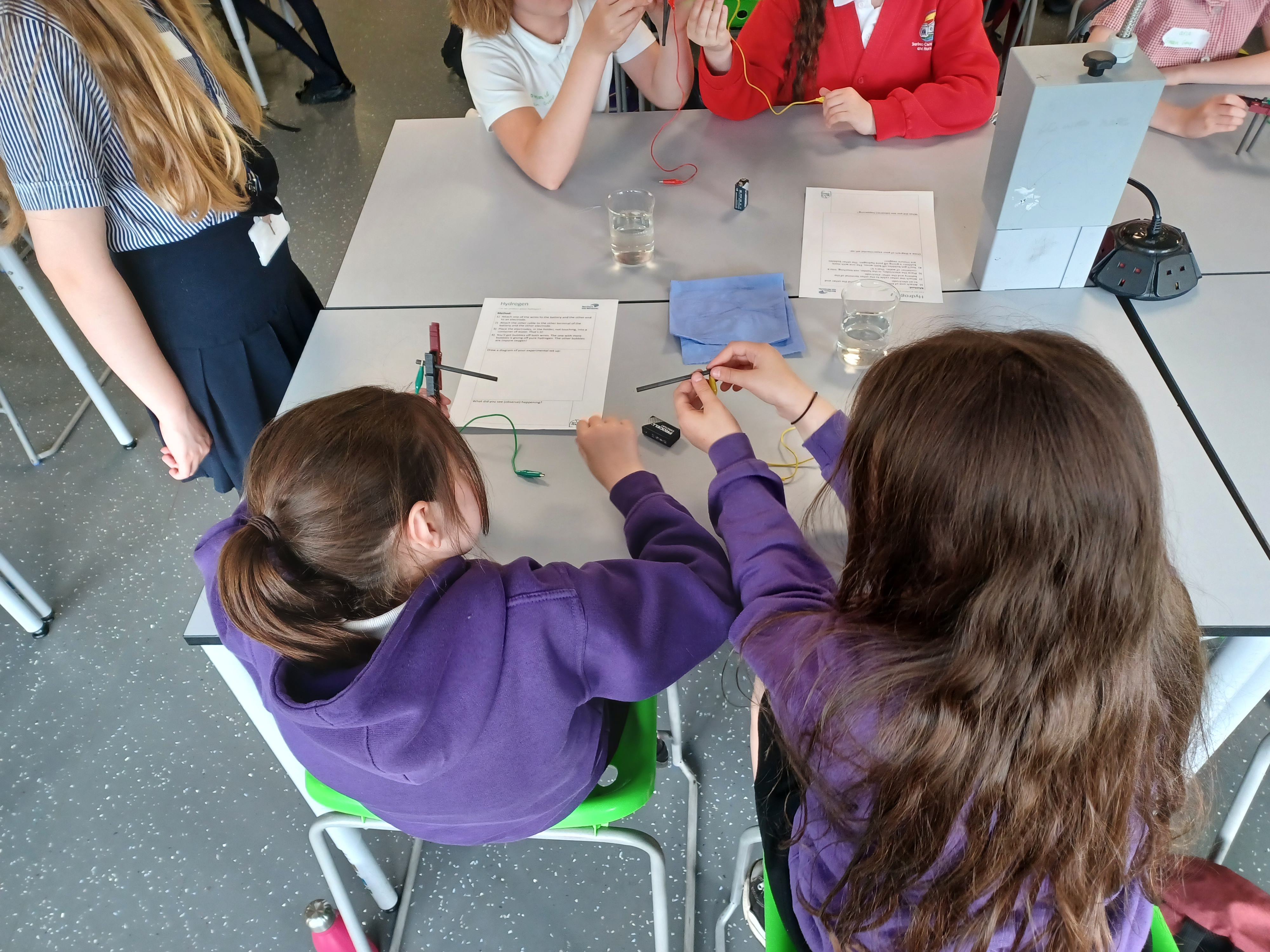 Schoolchildren at a table doing experiments